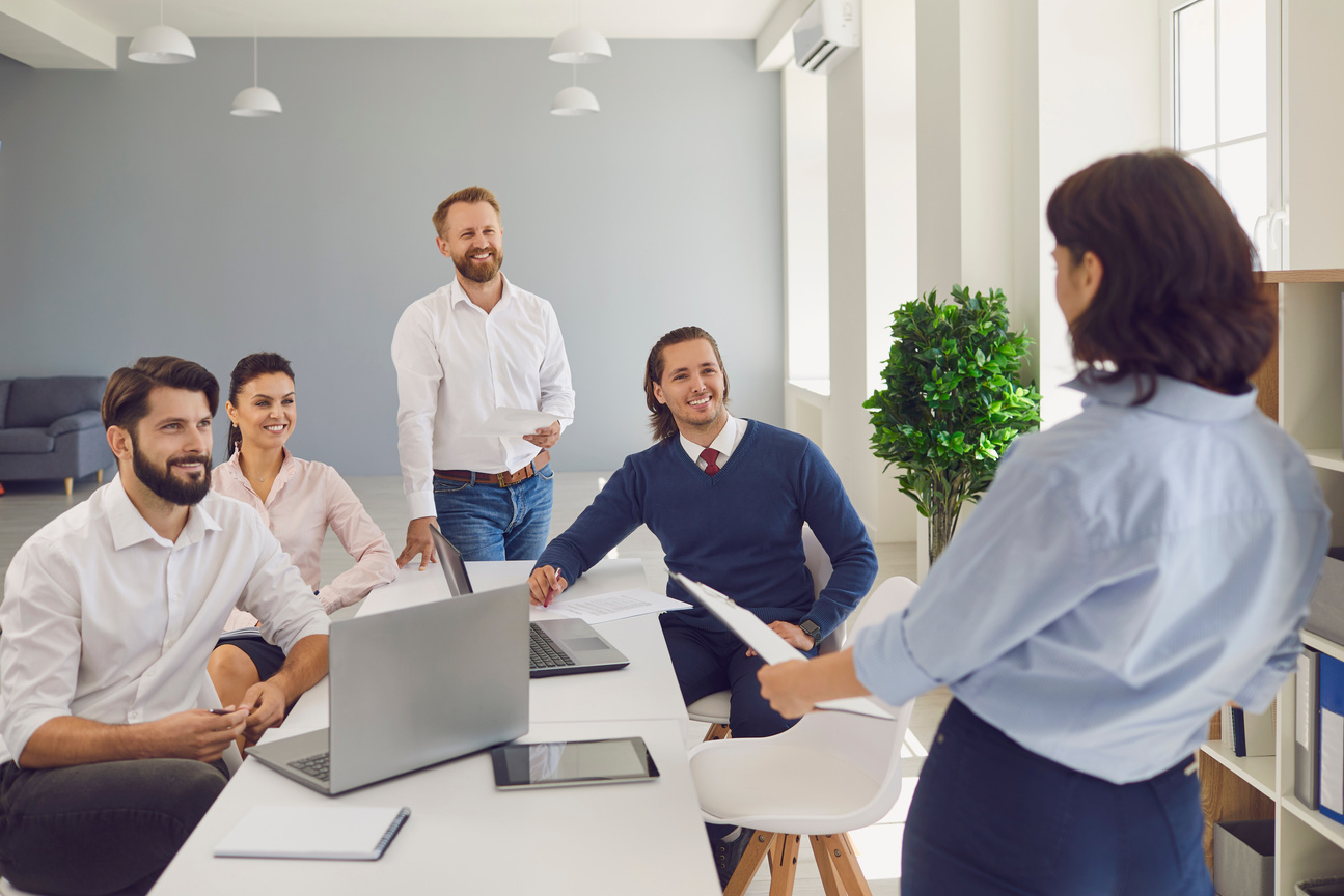 Woman Making Report for Team of Positive Company Colleagues in Corporate Meeting